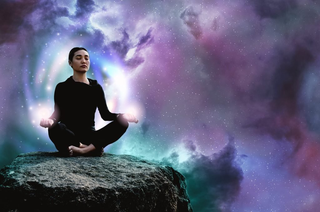 Full shot woman meditating rock