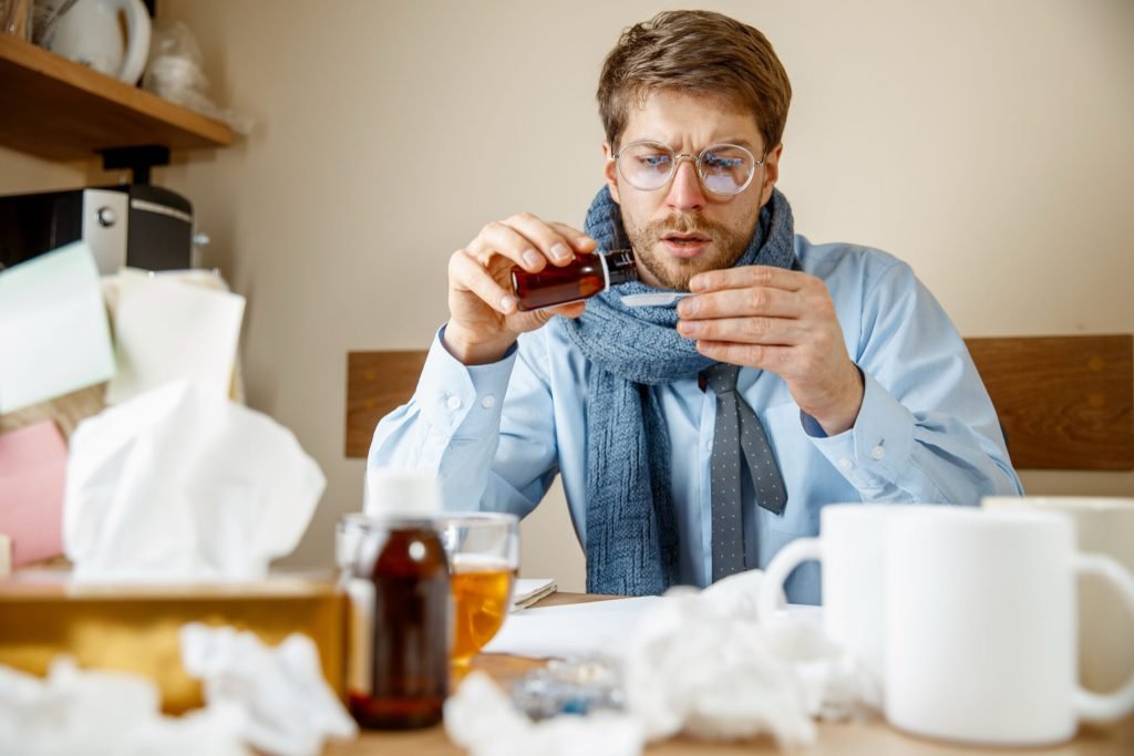 Man feeling sick tired man with cup working home businessman caught cold seasonal flu