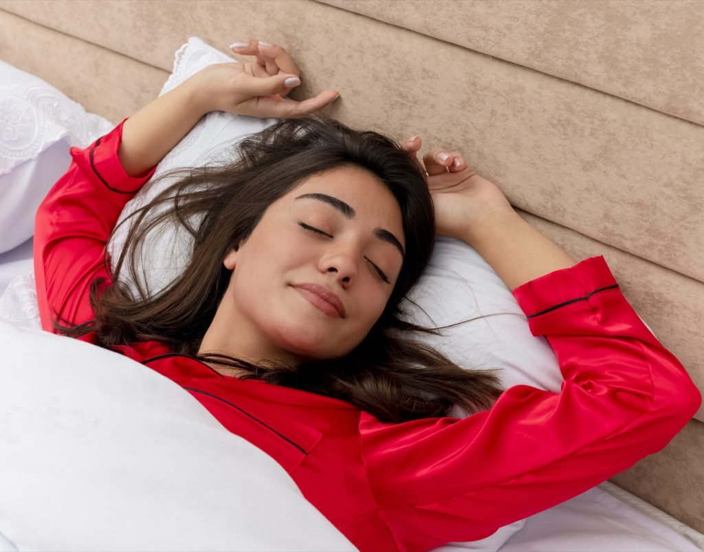 Young beautiful woman red pajamas relaxing bed