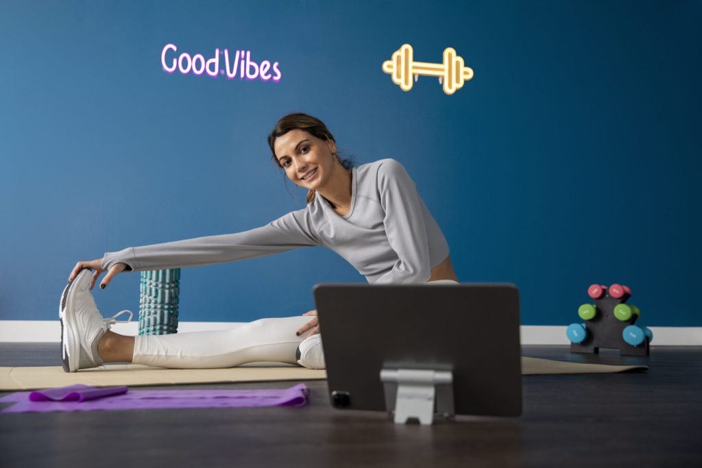 Female fitness instructor using tablet teach class from home