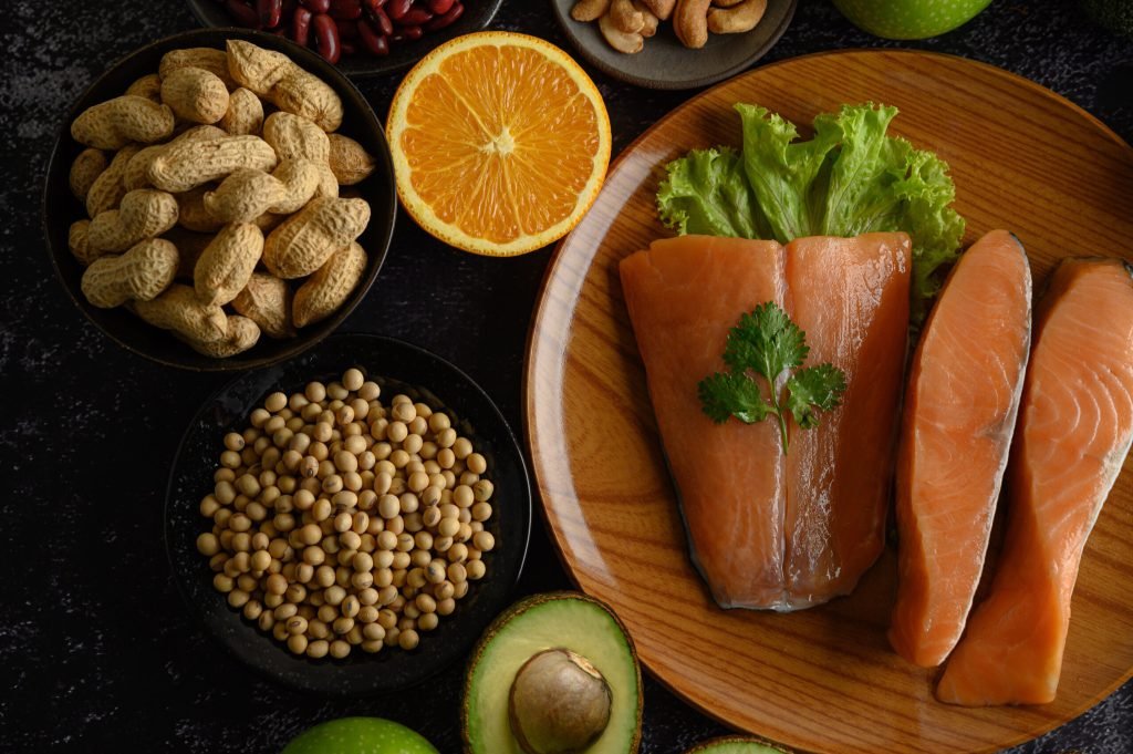 Legumes fruit salmon pieces wooden plate