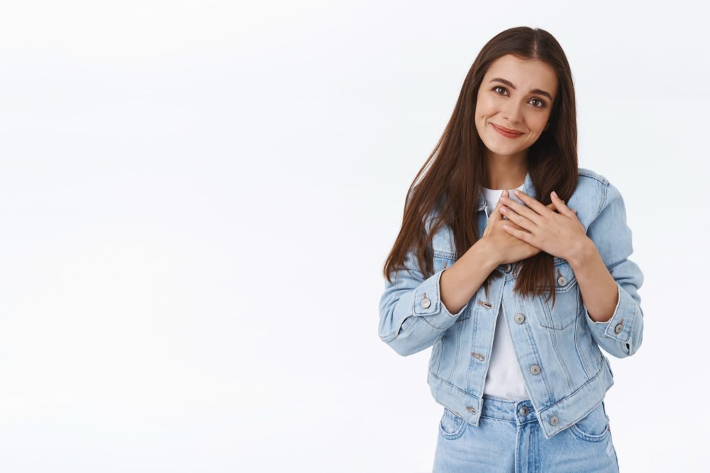 Lovely pretty brunette girl flattered with gift that warmthup autumn evening touching heart tilt head smiling sighing with...