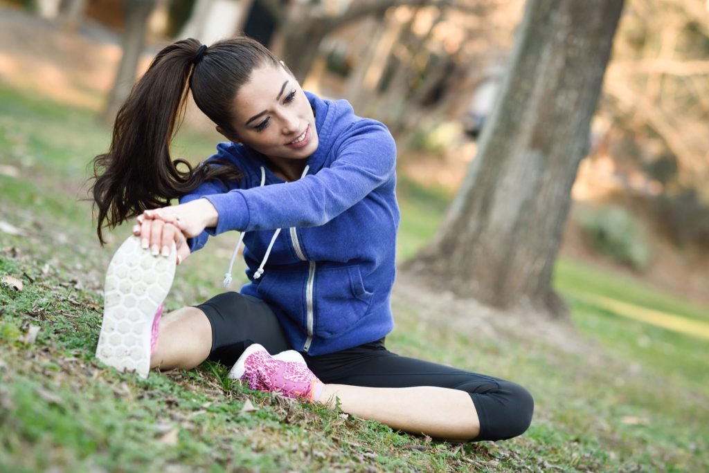 Sporty young woman preparing train