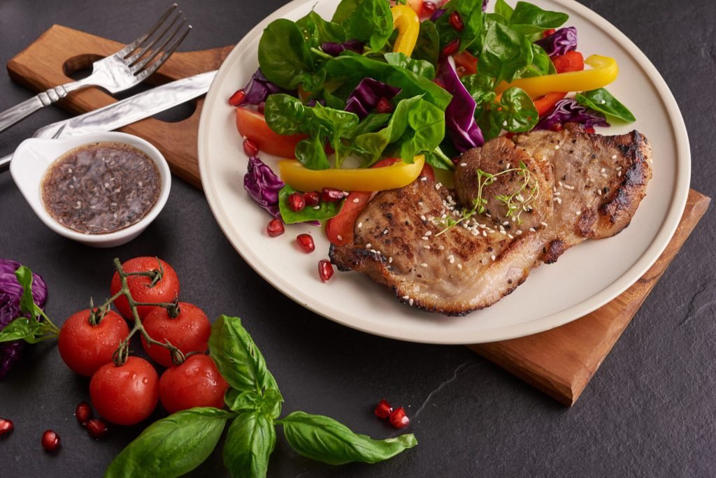 Grilled steak with fresh vegetable sweet pepper tomatoes red onion pink pepper spices home made tasty food concept tasty h...