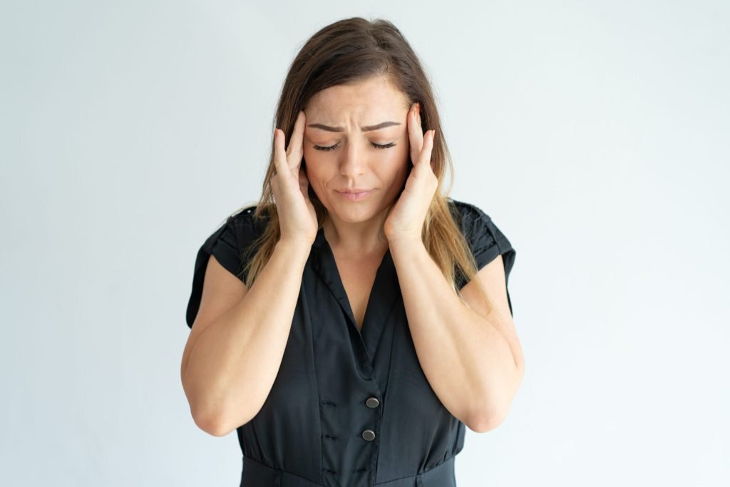 Tired stressed young woman black dress feeling headache massaging temples