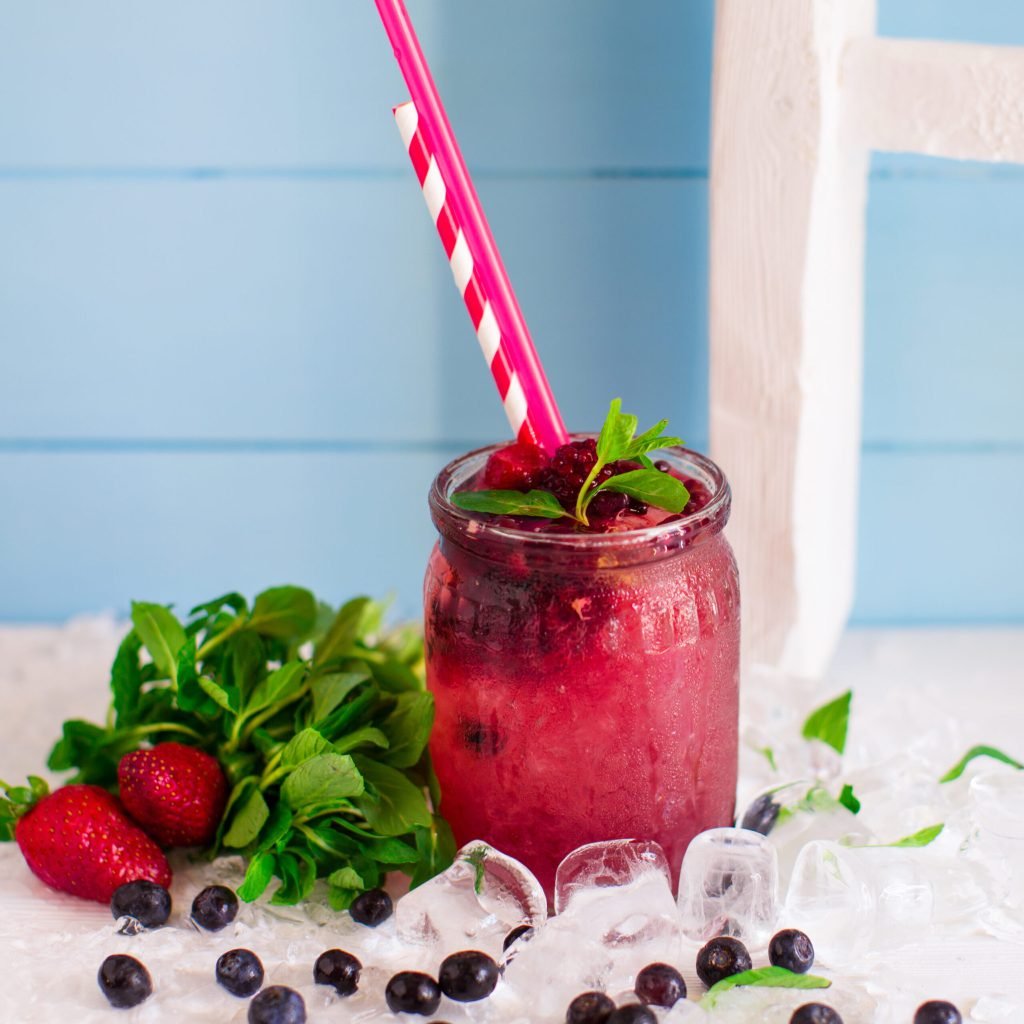 Berry cocktail with strawberry raspberry ice glass jar