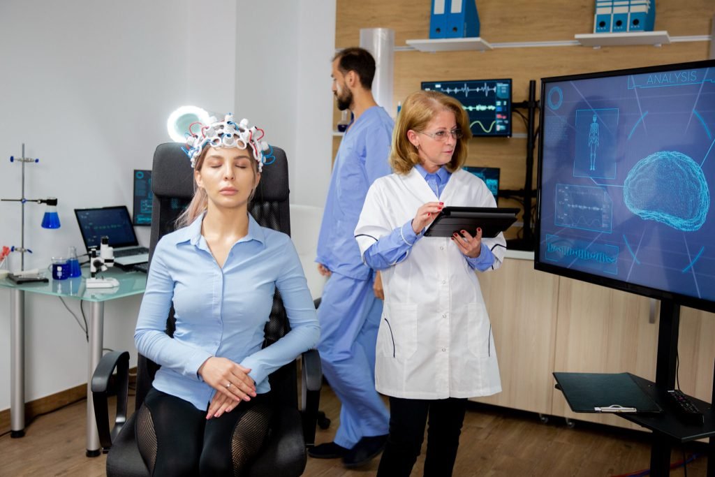 Doctor following procedure scanning girl s brain neurology scanning headset