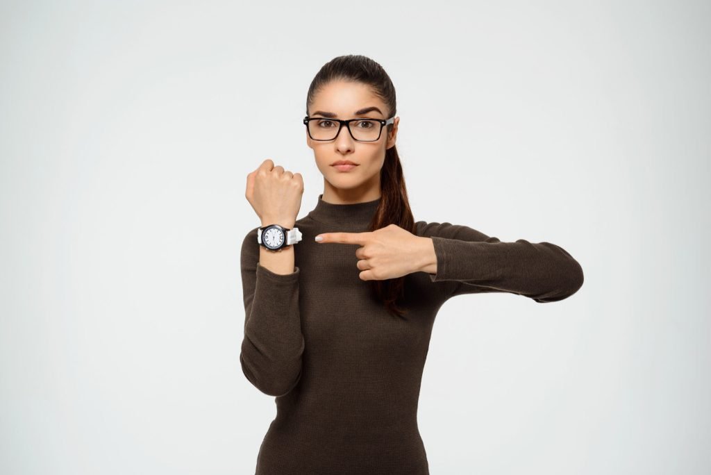 Woman pointing watch time is running out