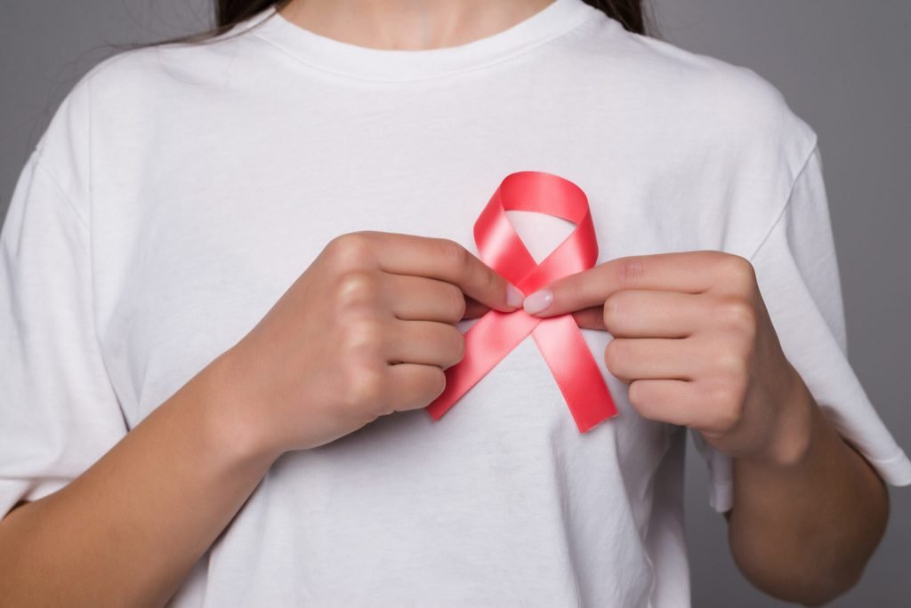 World breast cancer day concept health care woman wore white t shirt with pink ribbon awareness symbolic bow color raising...