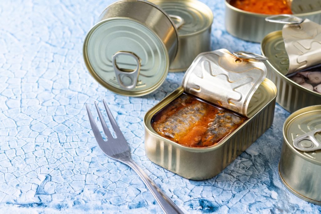Canned sardines metal can blue background