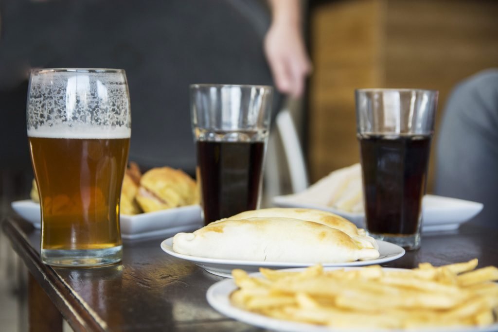 Fried snack with alcoholic drinks table bar