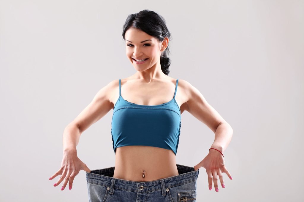 Portrait woman showing her weight loss