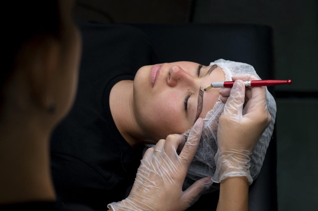 Beautician doing microblading procedure woman beauty salon