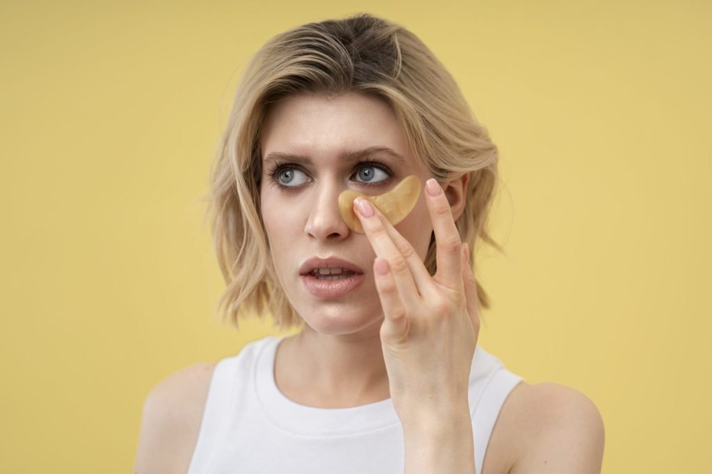 Blonde woman using anti dark circle