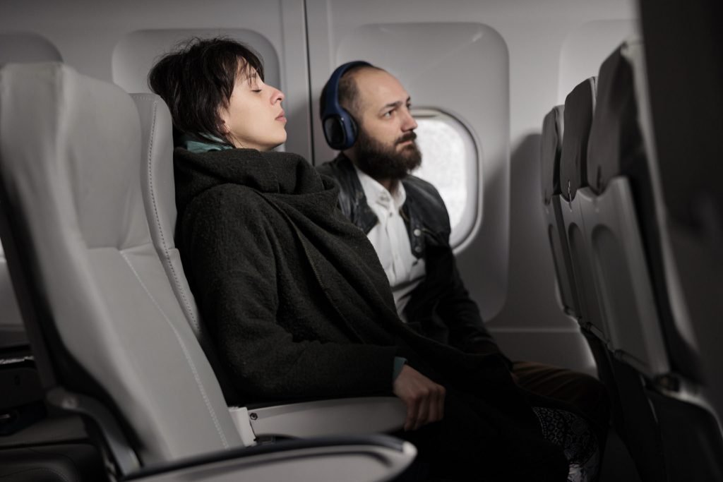 Frightened woman waiting plane takeoff fly abroad feeling scared about aerial departure jet travelling by airplane commerc...