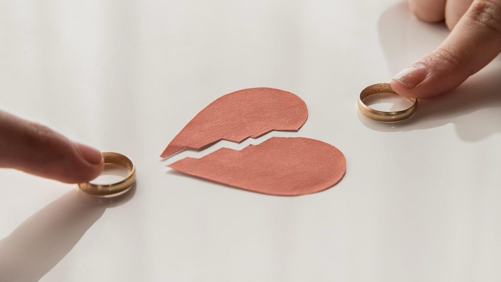 High angle hands touching wedding rings