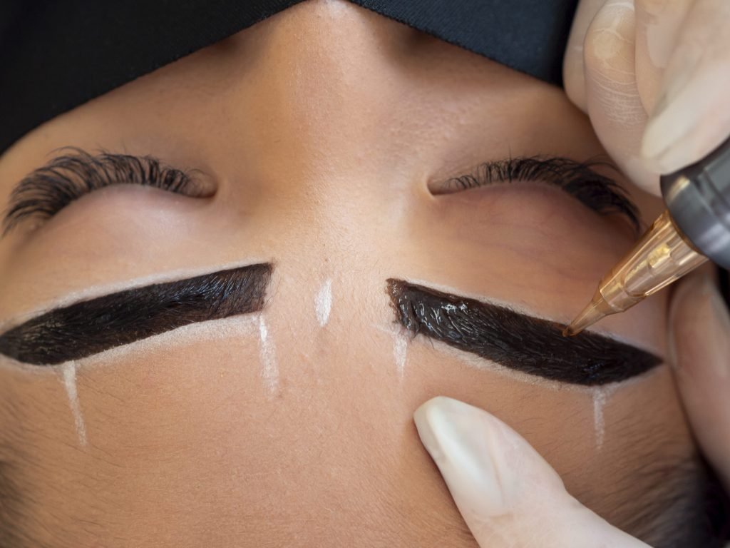 Young woman going through microblading procedure