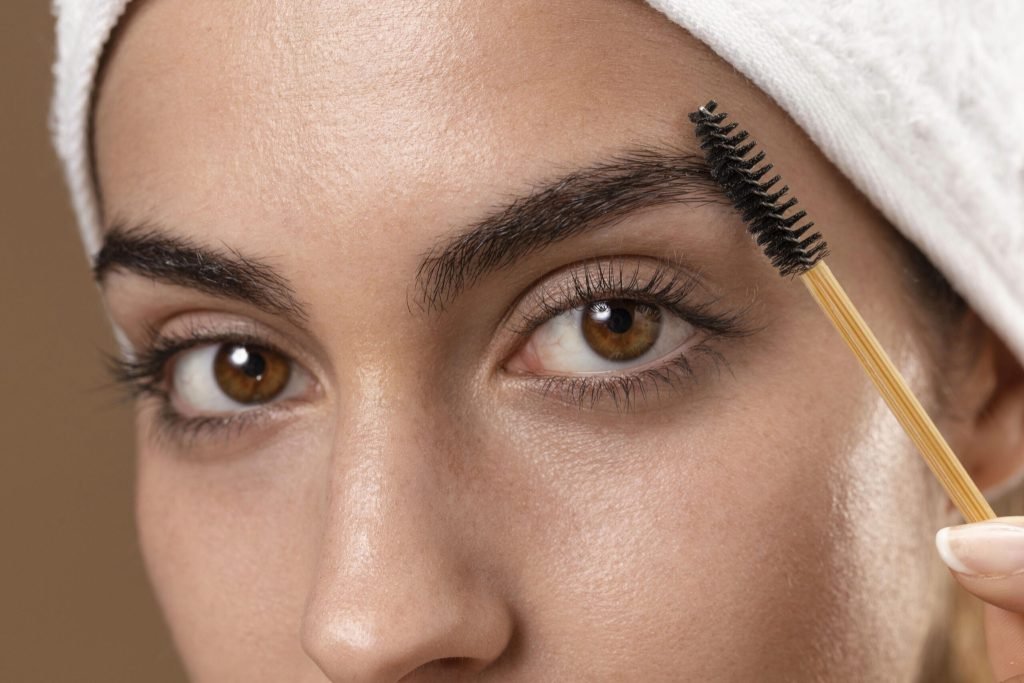 Young woman taking care her eyebrows