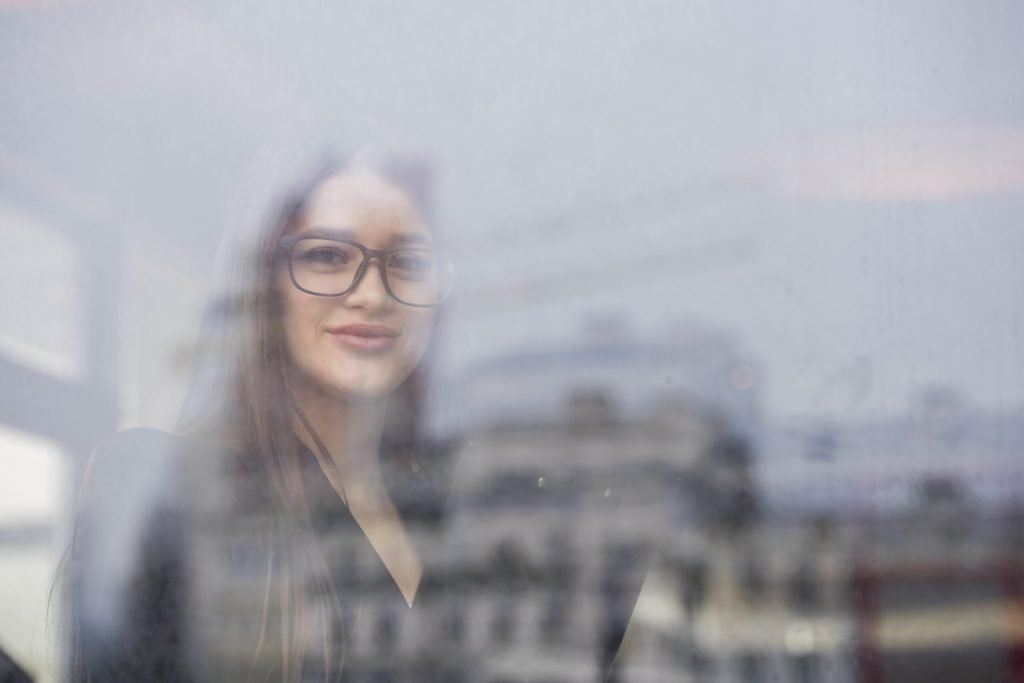 Brunette businesswoman through glass