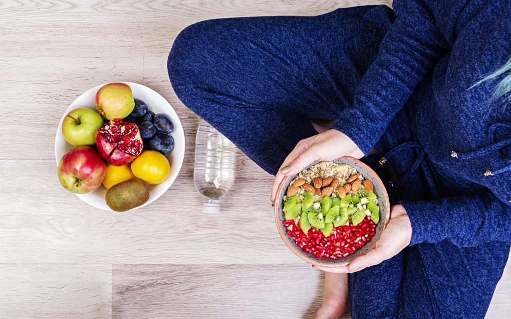 Fitness healthy lifestyle concept female is resting eating healthy oatmeal after workout top view