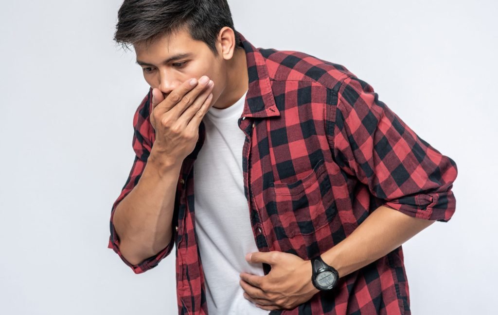 Man standing with stomachache put your hands your stomach cover your mouth