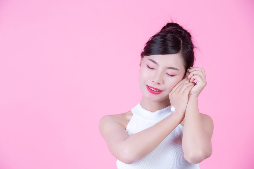 Beautiful woman with cream skin pink background