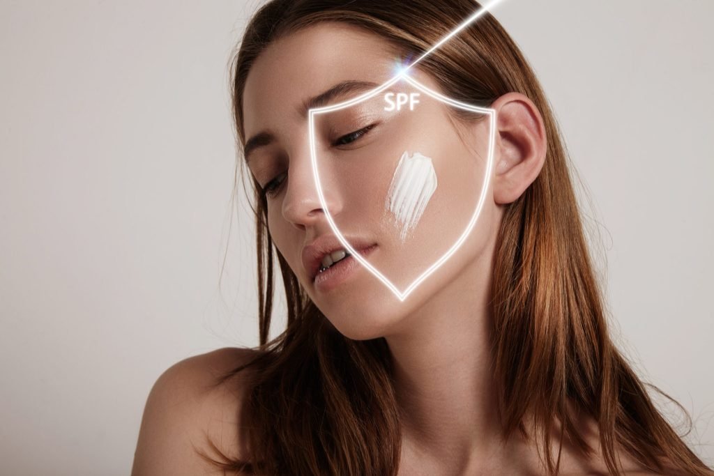 Woman s face into shield makes spf protection from ray