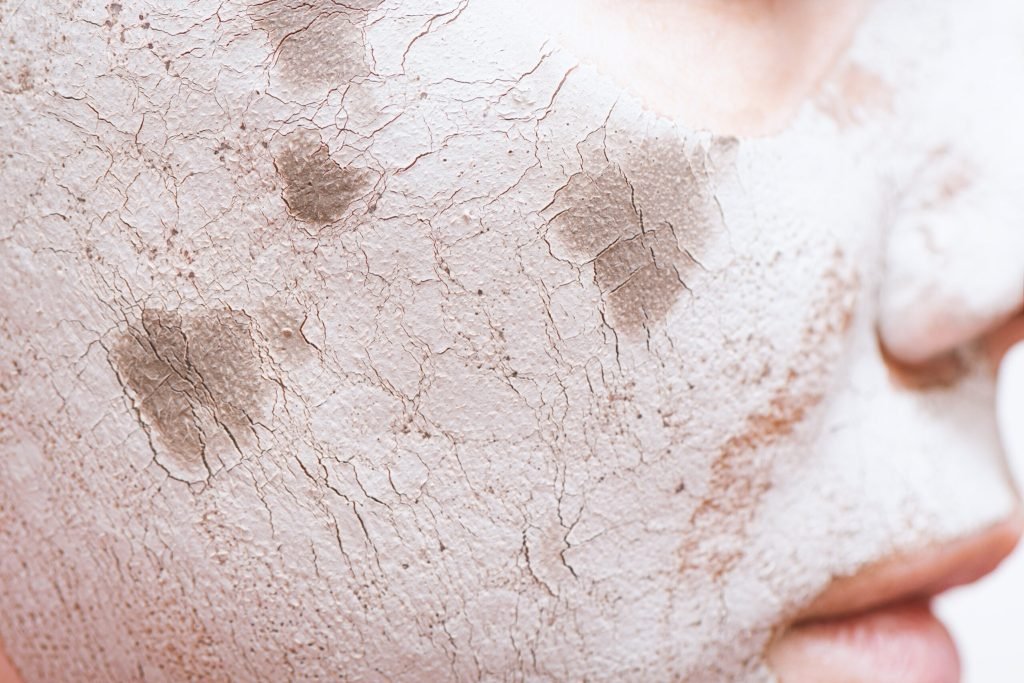 Clay facial mask female face close up