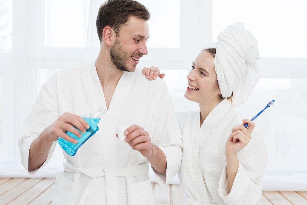 Front view couple bathrobes with mouthwash toothbrush