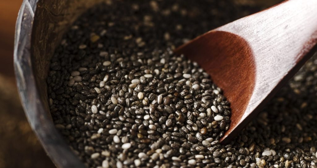 Rustic spoon taking organic seeds