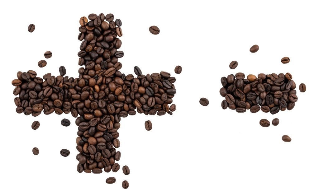 Symbol plus minus made from coffee beans isolated white background