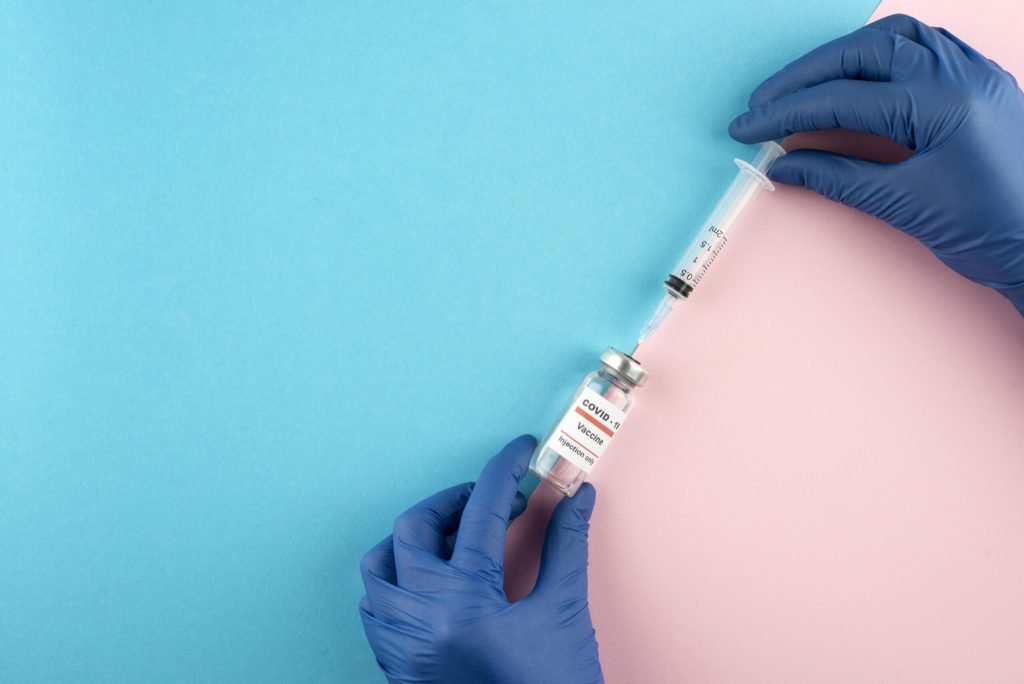 Close up hands holding coronavirus vaccine