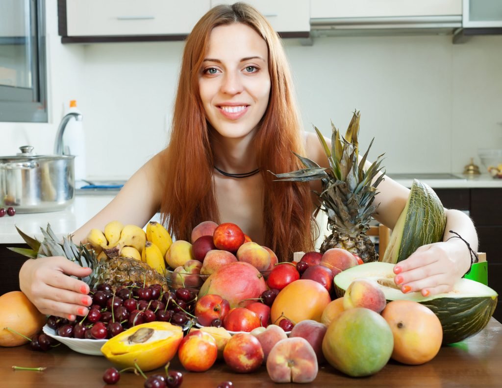 Happy long haired girl with fruits