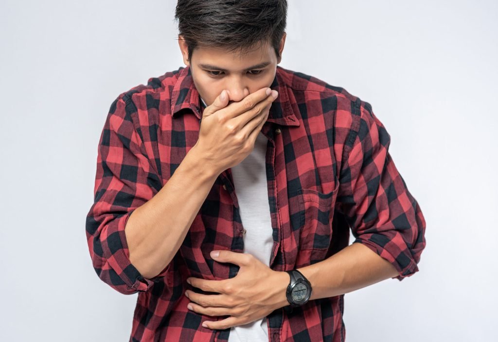 Man standing with stomachache put your hands your stomach cover your mouth