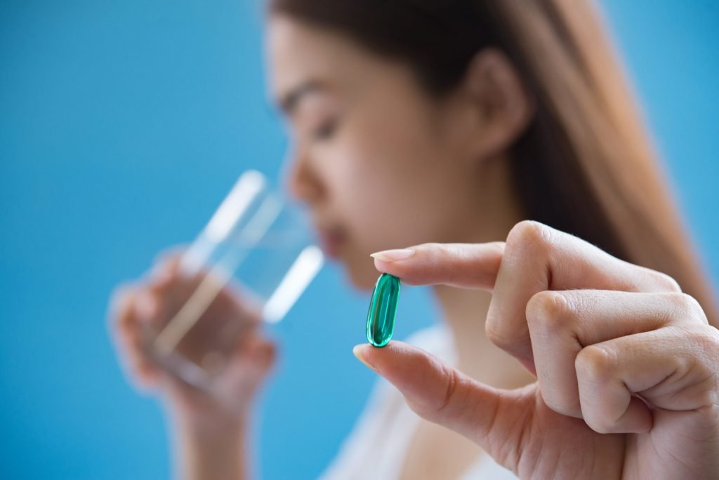 Sick woman taking medicine