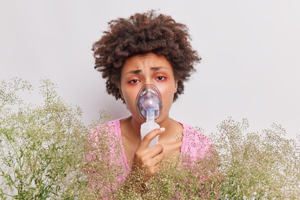 Woman wears oxygen mask does inhalation has red eyes suffers from allergy allergic pollen isolated white