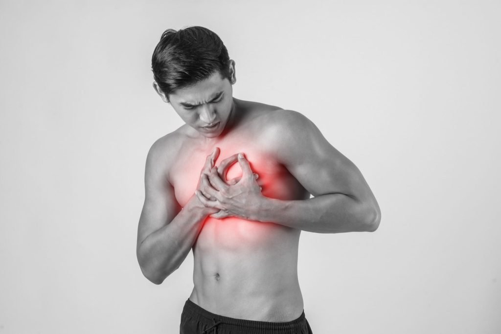 Young man has heart attack isolated white background