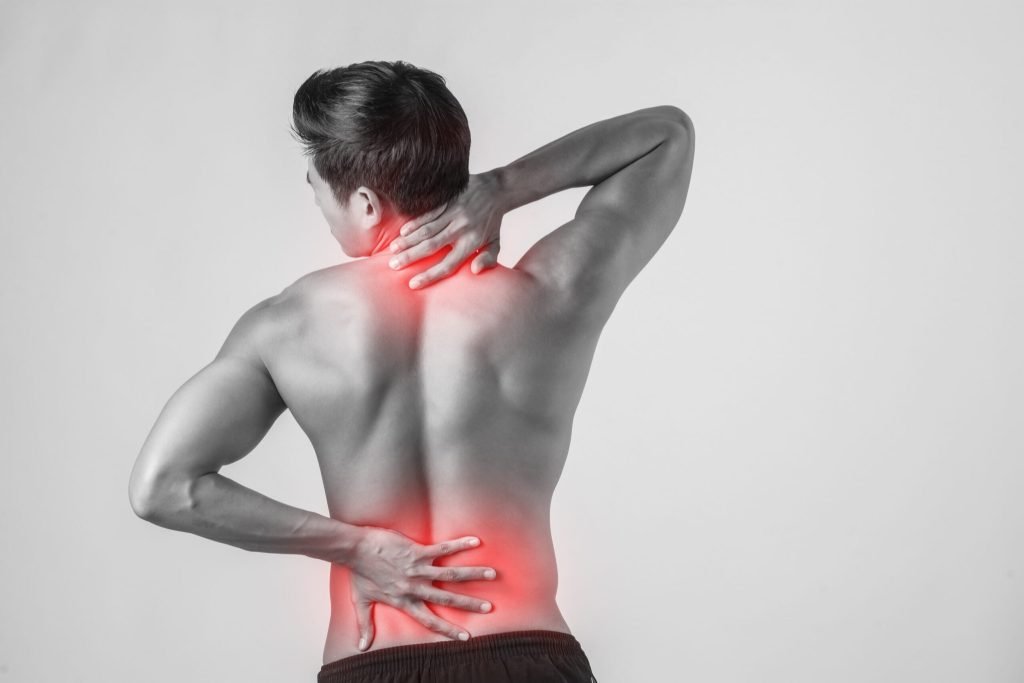 Close up man rubbing his painful back isolated white background
