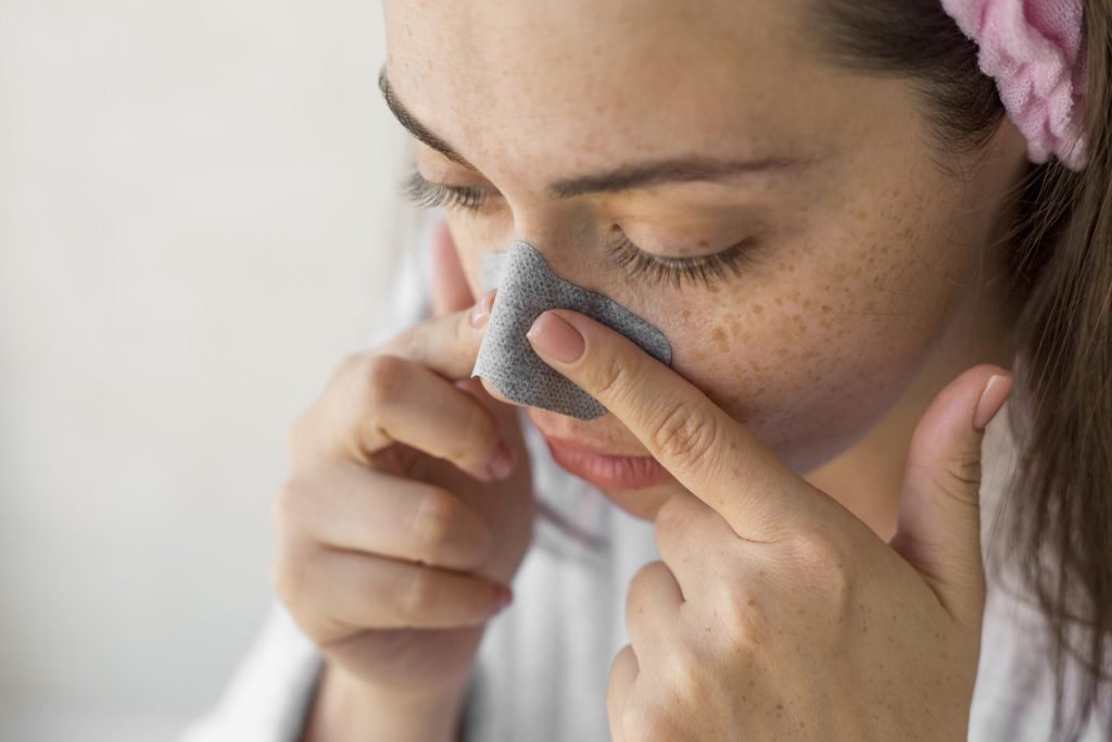 Close up woman using nose patch