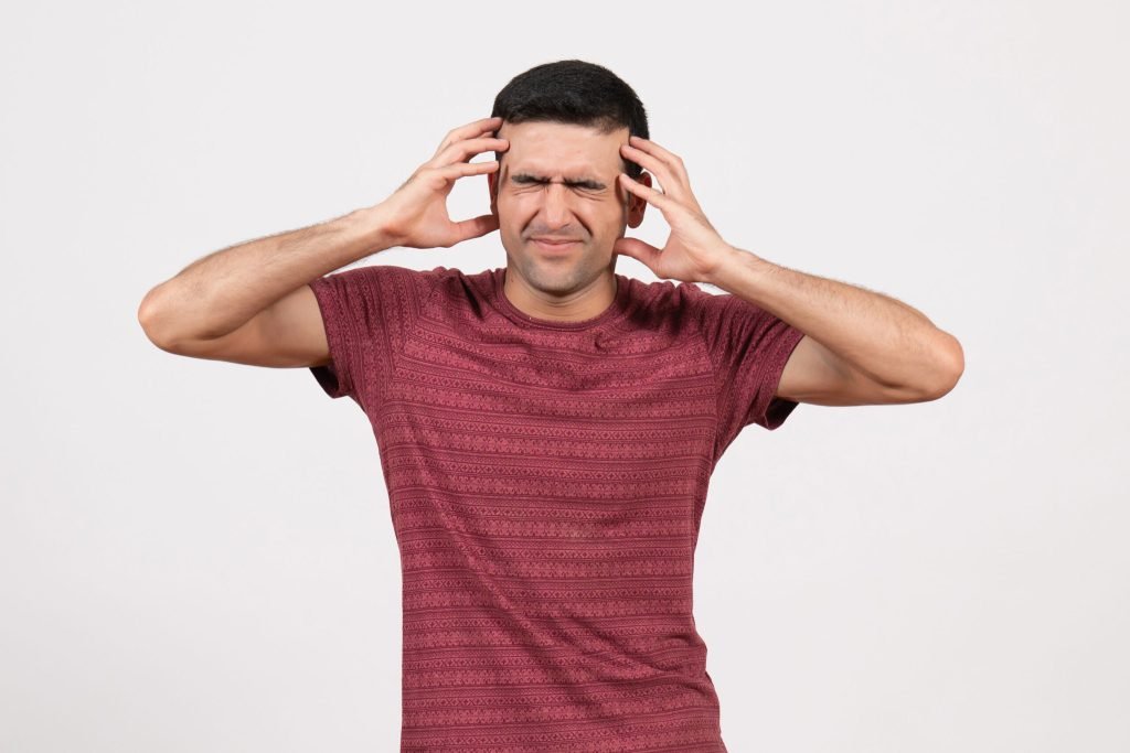 Front view young male dark red t shirt standing white background