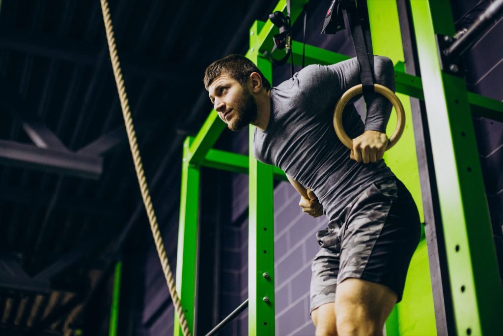 Male trainer exercising gym