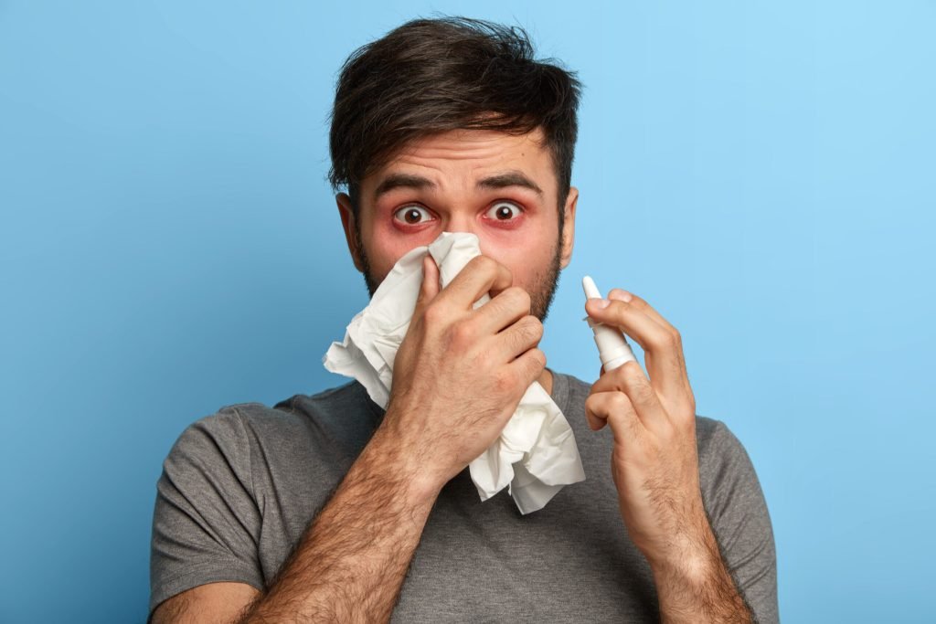 Sick young man suffering from allergy isolated