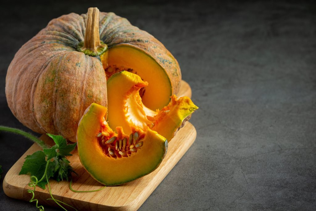 Chopped raw pumpkin put wooden cutting board