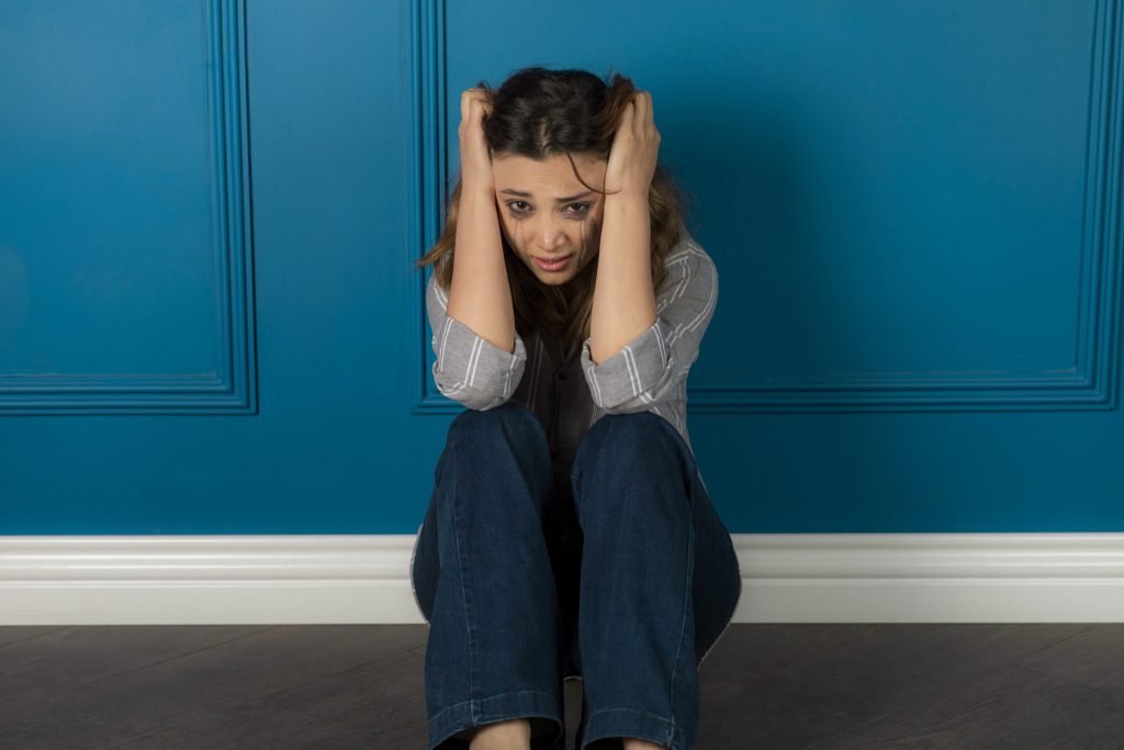 Portrait depressed girl sitting floor crying high quality photo