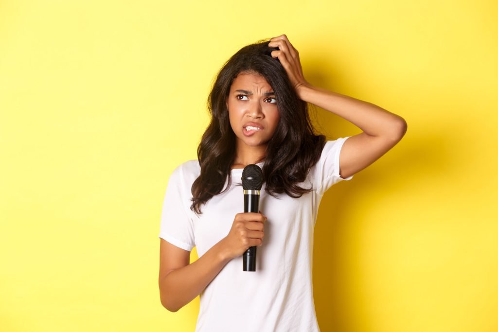 Image indecisive africanamerican girl holding microphone looking hesitant standing