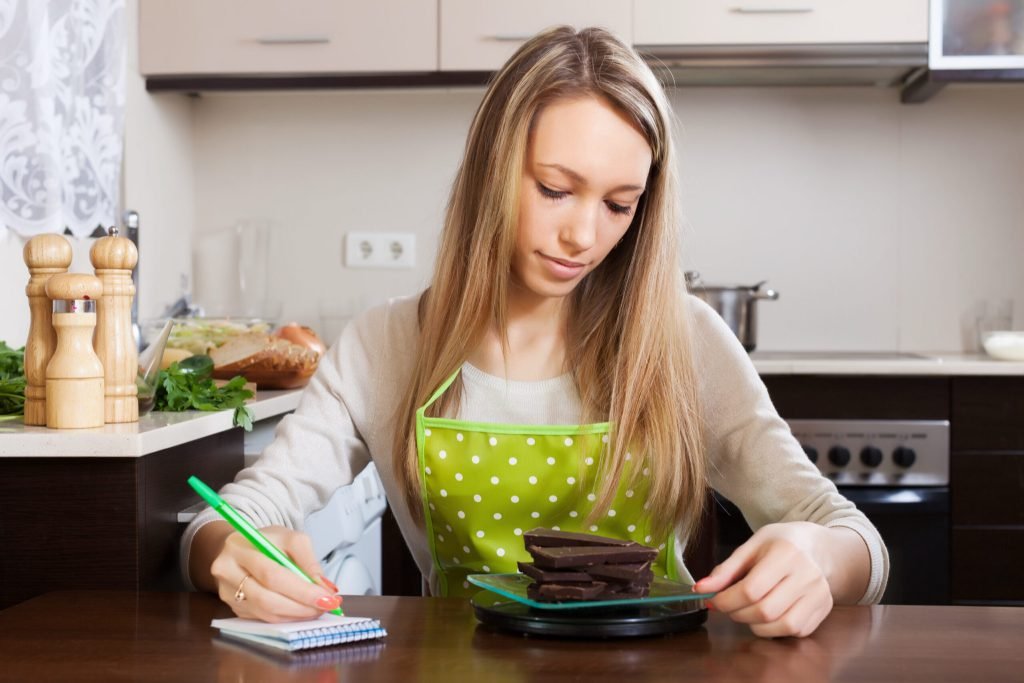 Woman weighing chocolate scales